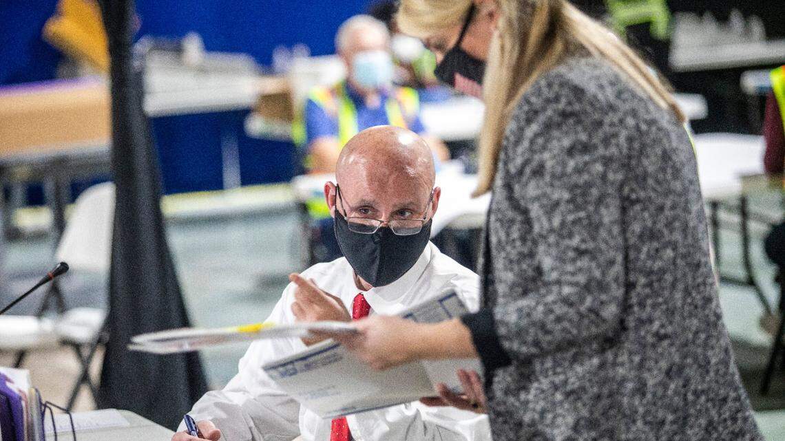 Election workers process absentee ballots Tuesday, Nov. 10, 2020 at the Wake County Board of Elections Operations Center in Raleigh.