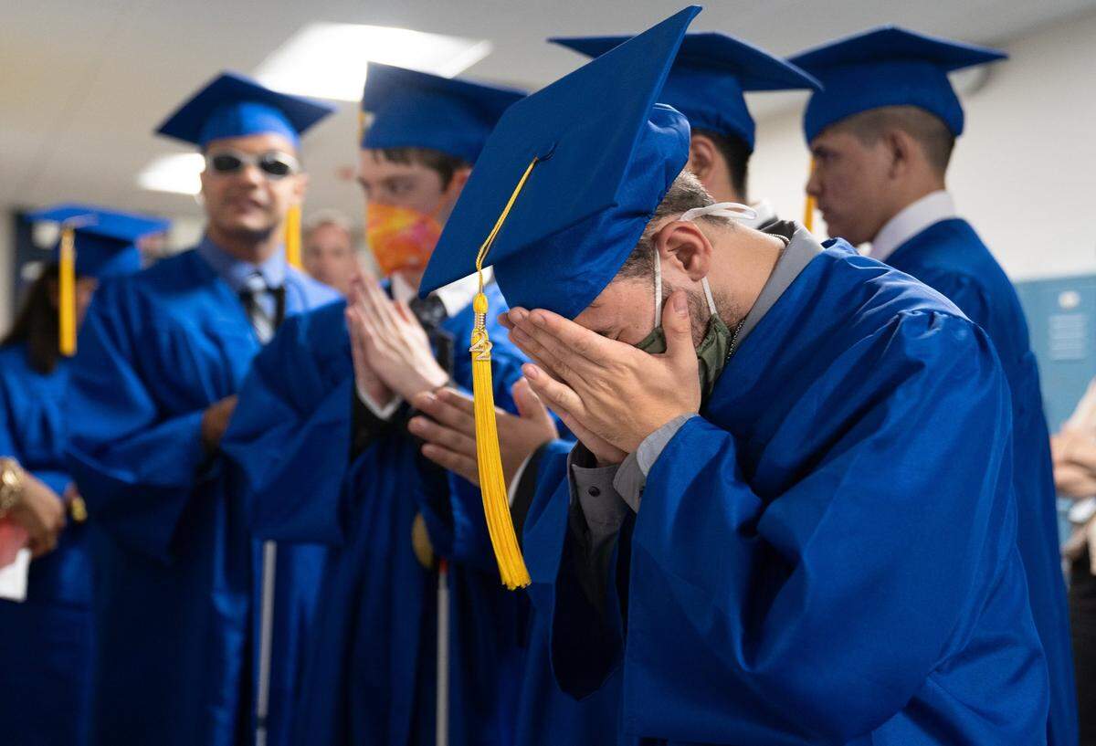 Class of 2022 Graduate Avery Wyatt Boyer from Charlotte, N.C. joins his classmates in prayer before the group’s Commencement ceremony at Lineberry Hall at the Governor Morehead School campus in Raleigh, N.C. on Friday, June 3, 2022. Students such as Boyer come from across the state to the school for its education services for the deaf and visually impaired.