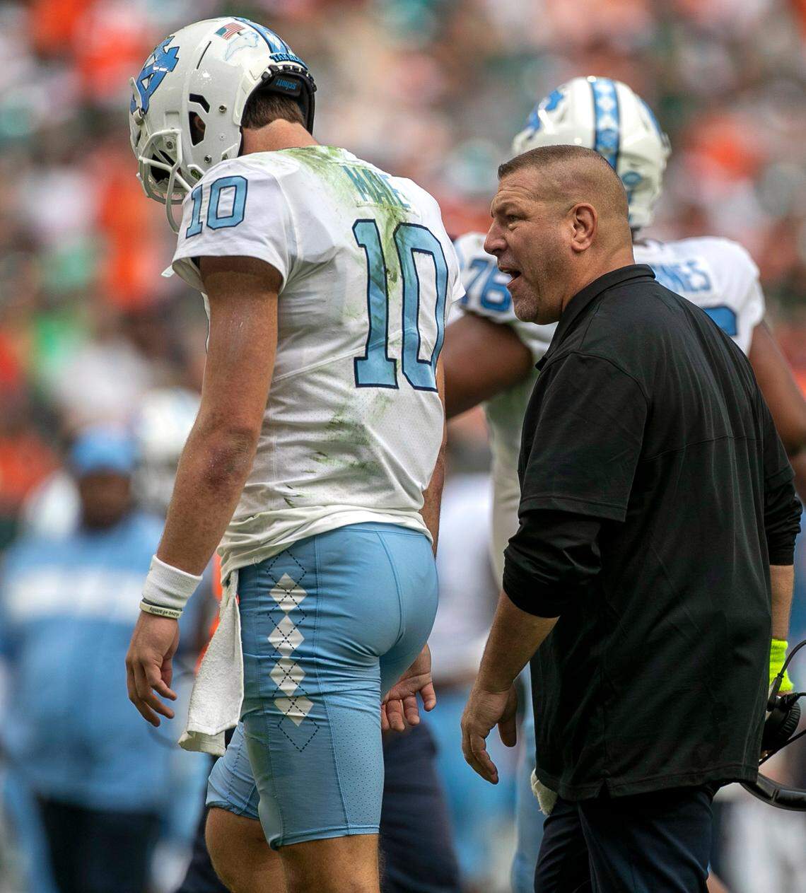 North Carolina offensive coordinator Phil Longo has a word with quarterback Drake Maye after turning the ball over to Miami on a failed fourth down attempt in the second quarter on Saturday, October 8, 2022 at Hard Rock Stadium in Miami Gardens, Florida.