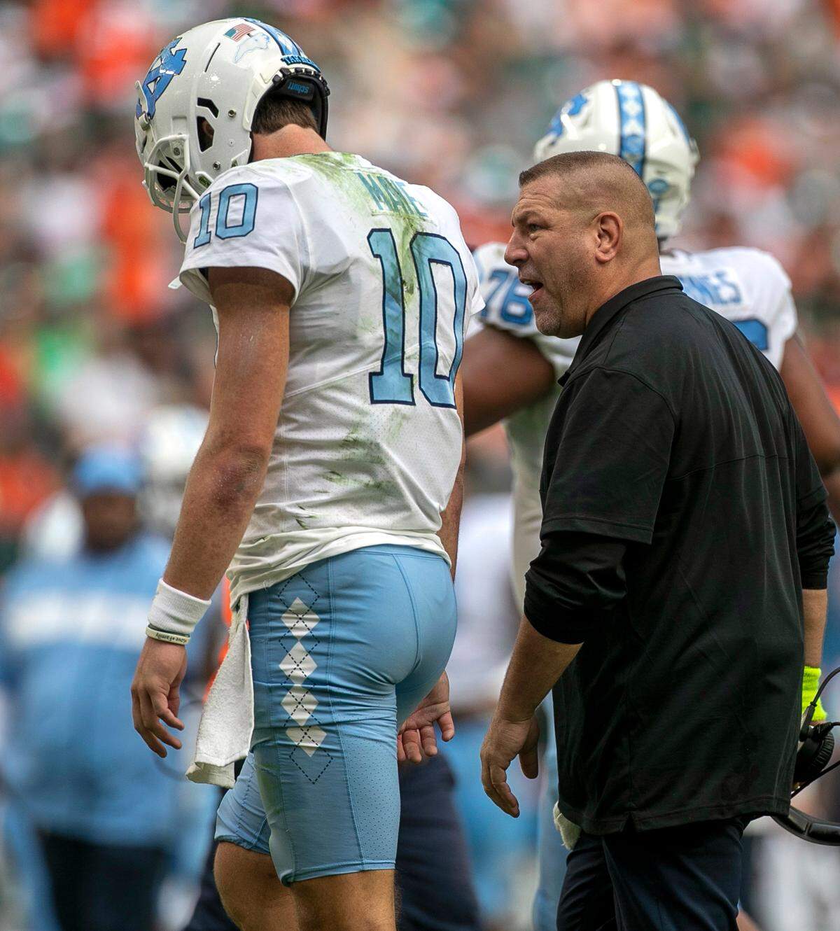 North Carolina offensive coordinator Phil Longo has a word with quarterback Drake Maye after turning the ball over to Miami on a failed fourth down attempt in the second quarter on Saturday, October 8, 2022 at Hard Rock Stadium in Miami Gardens, Florida.