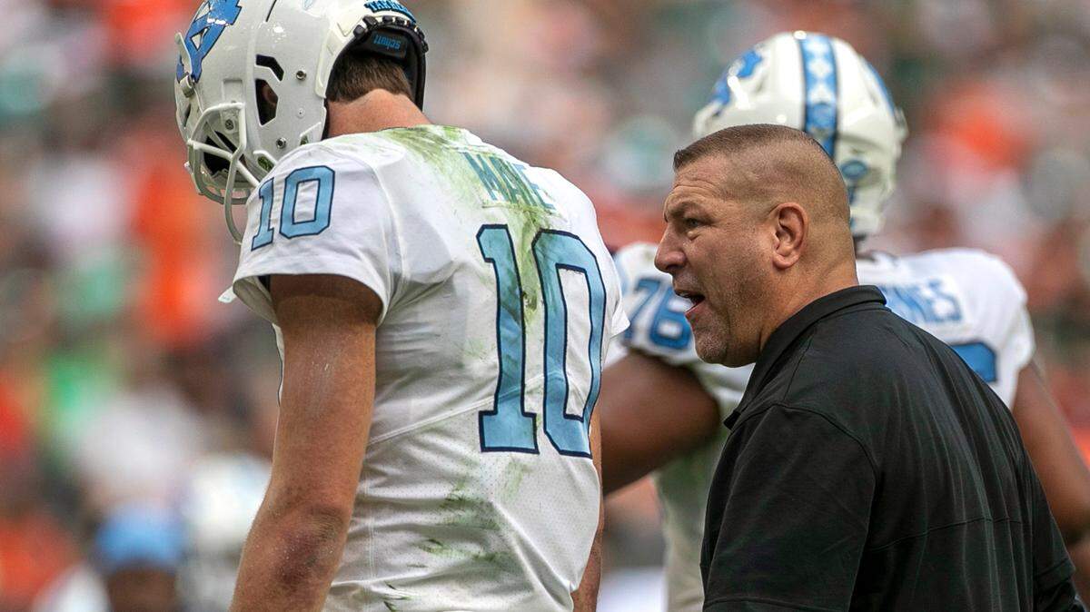 North Carolina offensive coordinator Phil Longo has a word with quarterback Drake Maye after turning the ball over to Miami on a failed fourth down attempt in the second quarter on Saturday, October 8, 2022 at Hard Rock Stadium in Miami Gardens, Florida.