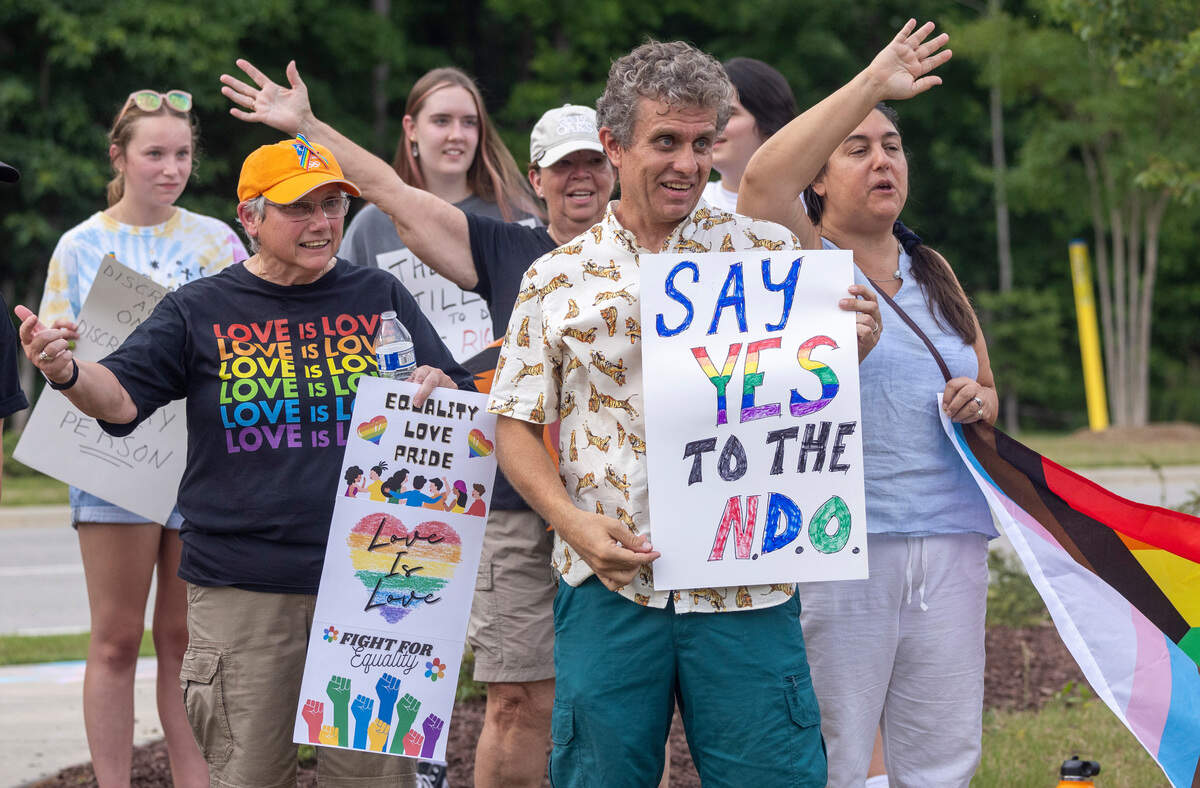 About 50 demonstrators rally outside the Holly Springs Law Enforcement Center to urge the town council to sign a Pride Month proclamation and adopt a non-discrimination ordinance. Holly Springs Mayor Sean Mayefskie refused to sign the proclamation. He said then that the town already has “diverse and inclusive” policies.