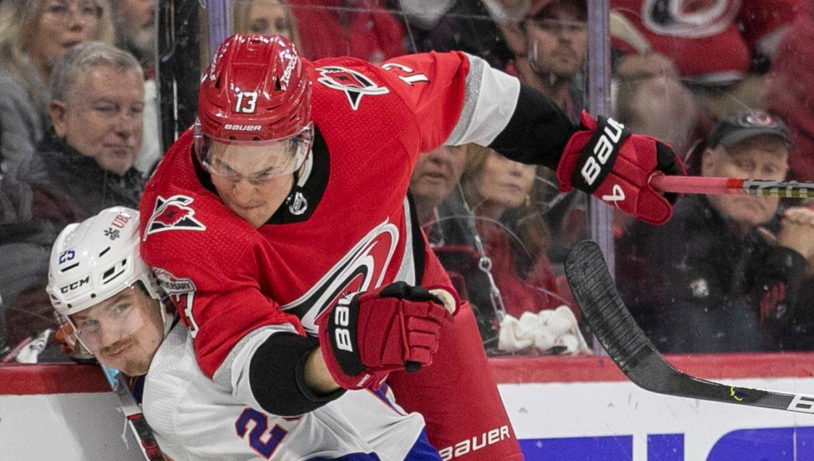 The Carolina Hurricanes Jesse Piljujarvi (13) checks the New York Islanders Sebastian Aho (25) in the first period during Game 5 of their Stanley Cup series on Tuesday, April 25, 2023 at PNC Arena in Raleigh, N.C.
