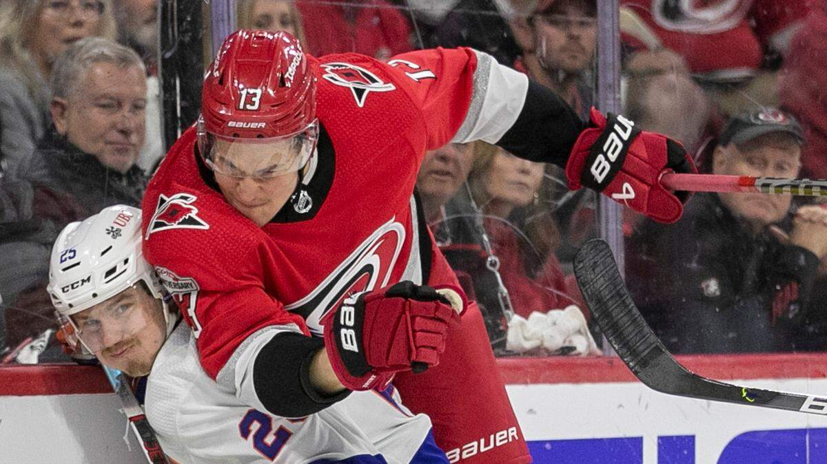 The Carolina Hurricanes Jesse Piljujarvi (13) checks the New York Islanders Sebastian Aho (25) in the first period during Game 5 of their Stanley Cup series on Tuesday, April 25, 2023 at PNC Arena in Raleigh, N.C.