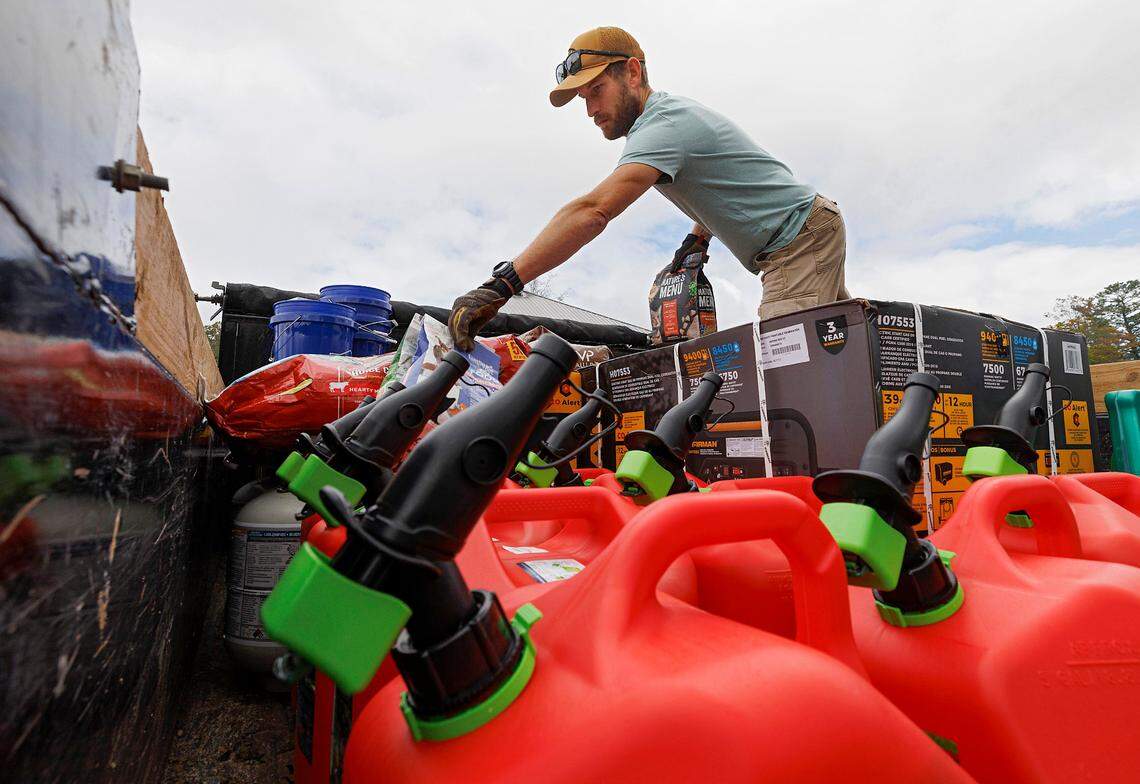 Justin Chew loads pet food onto a truck in Banner Elk, N.C. on Tuesday, Oct. 1, 2024. A team of volunteers delivered food, clothes and other supplies to communities in Avery County impacted by Hurricane Helene.