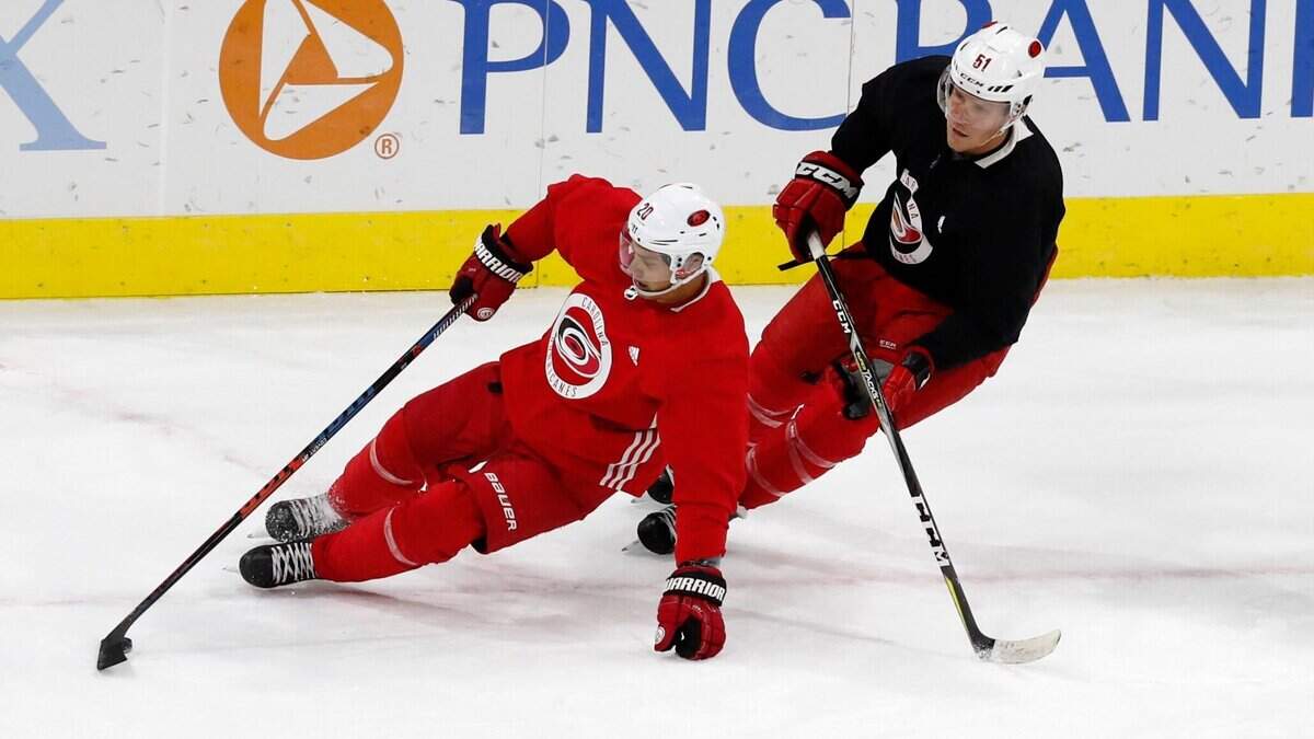 Carolina center Sebastian Aho (20) gets around Jake Gardiner (51) during the Carolina Hurricanes’ on-ice workouts at PNC Arena in Raleigh, N.C., Monday, July 13, 2020.