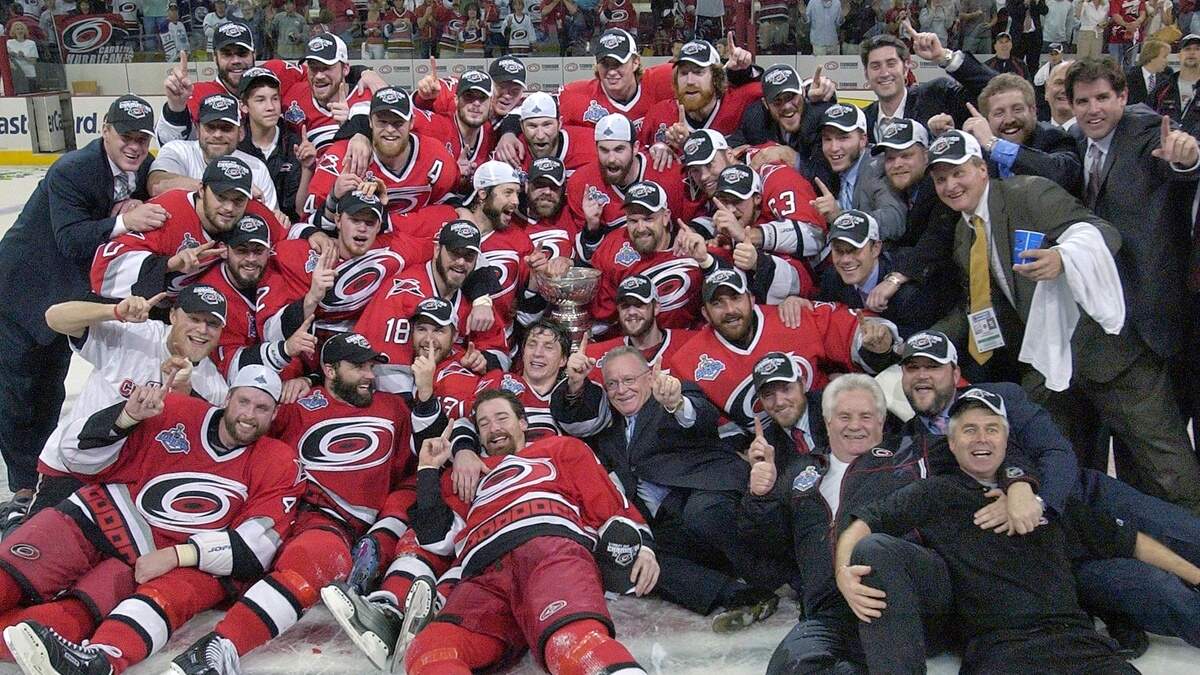 Rod Brind’Amour, center, and Justin Williams, bottom center, celebrate with the Stanley Cup in June 2006.