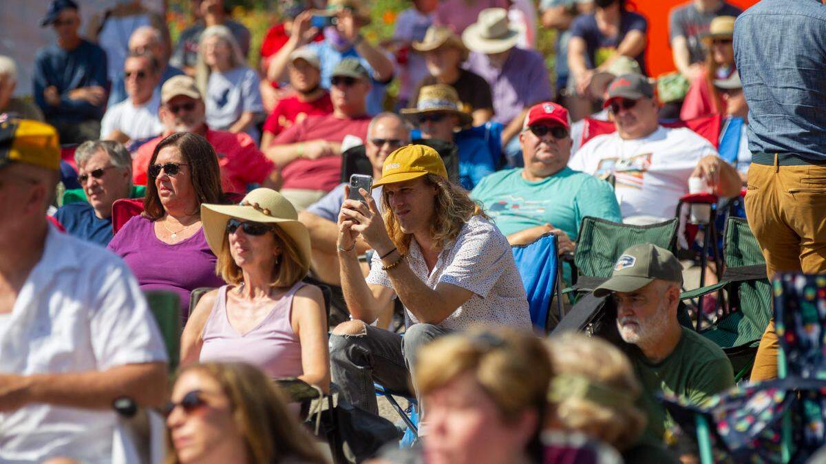 Bluegrass fans watch as the Chatham Rabbits perform outside the Duke Energy Center for the Performing Arts during the IBMA World of Bluegrass festival in downtown Raleigh Friday, Oct. 1, 2021.