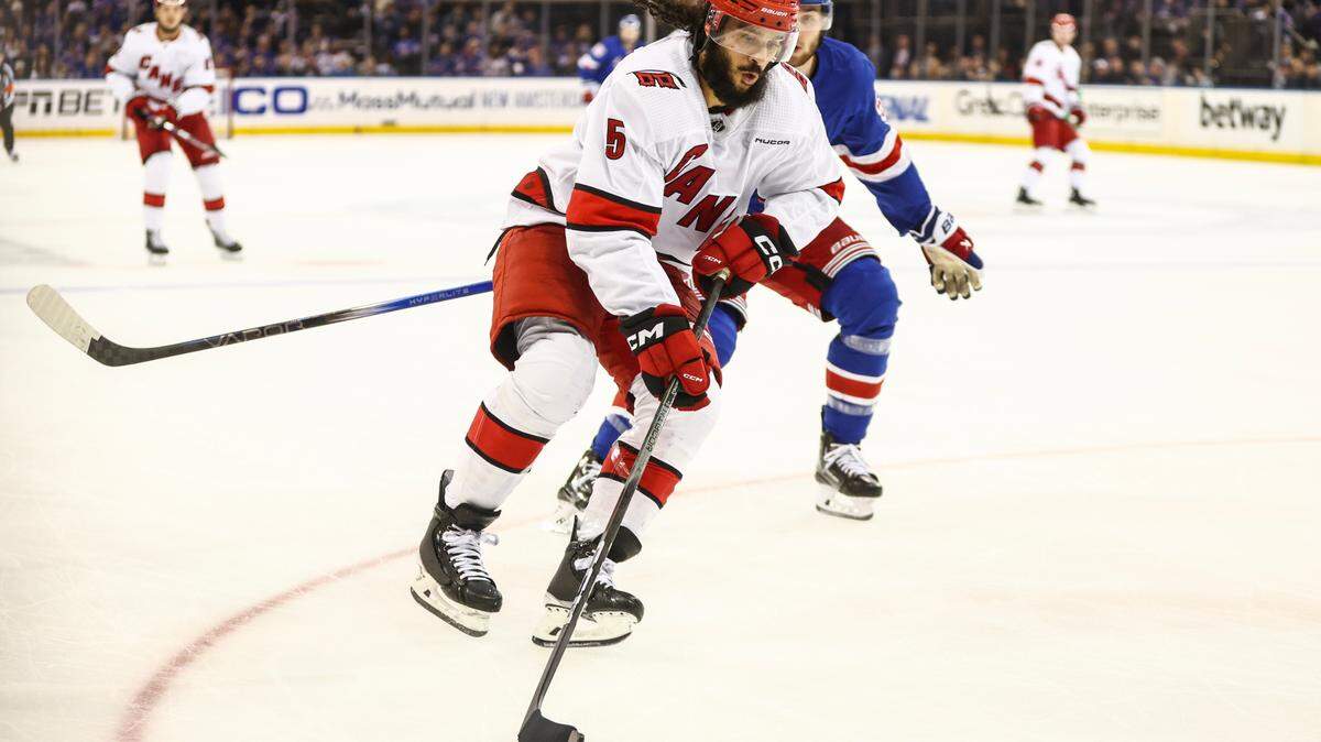 May 5, 2024; New York, New York, USA; Carolina Hurricanes defenseman Jalen Chatfield (5) controls the puck in the second period against the New York Rangers in game one of the second round of the 2024 Stanley Cup Playoffs at Madison Square Garden. Mandatory Credit: Wendell Cruz-USA TODAY Sports