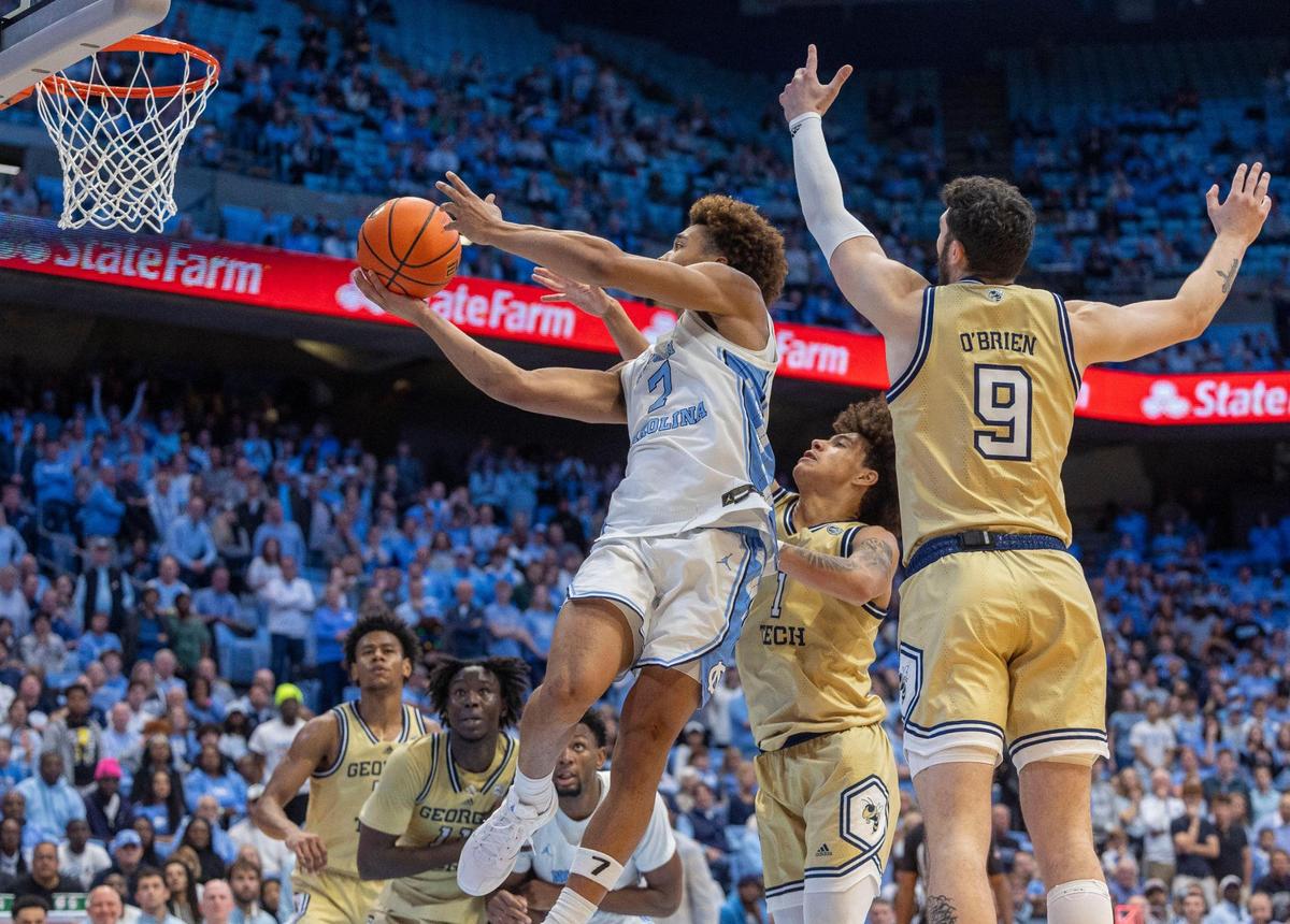 North Carolina guard Seth Trimble (7) drives to the basket between Georgia Tech’s Naithan George (1) and Luke O’Brien (9) in the first half on Saturday, December 7, 2024 at the Smith Center in Chapel Hill, N.C.