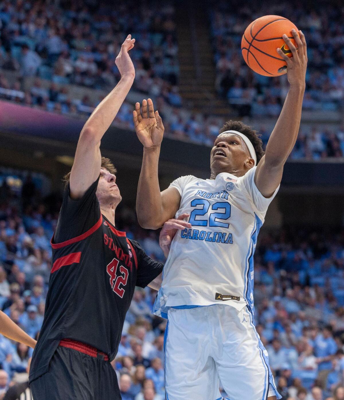 North Carolina forward Ven-Allen Lubin (22) puts up a shot against Stanford’s Maxime Raynaud (42) in the first half on Saturday, January 18, 2025 at the Smith Center in Chapel Hill, N.C.