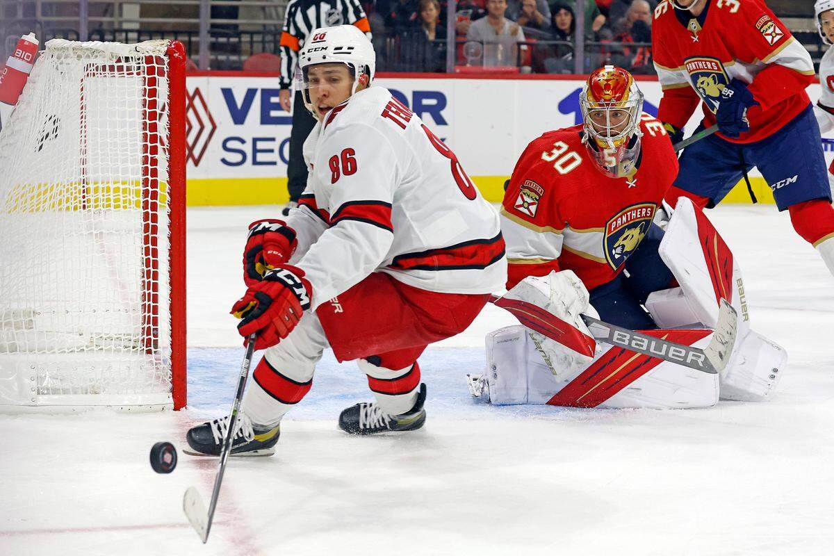 Carolina Hurricanes’ Teuvo Teravainen (86) gathers a loose puck with Florida Panthers goaltender Spencer Knight (30) looking on during the third period of a preseason NHL hockey game in Raleigh, N.C., Saturday, Oct. 1, 2022. (AP Photo/Karl B DeBlaker)