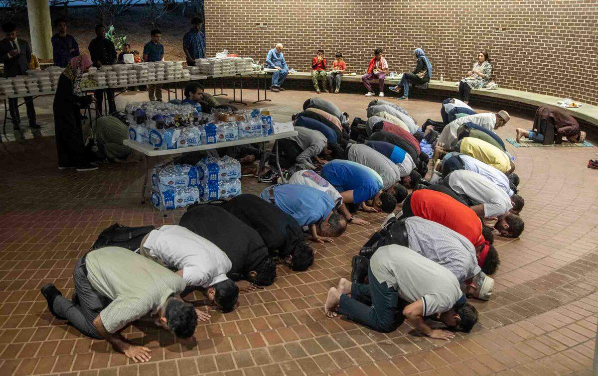 Area Muslims pray and break fast outside a Raleigh City Council meeting Tuesday, April 4, 2023. Some community members worry that the Shaw University closed its mosque to the public “as a stalling measure while it seeks rezoning to redeveloped parts of its historic campus,” The News & Observer previously reported.