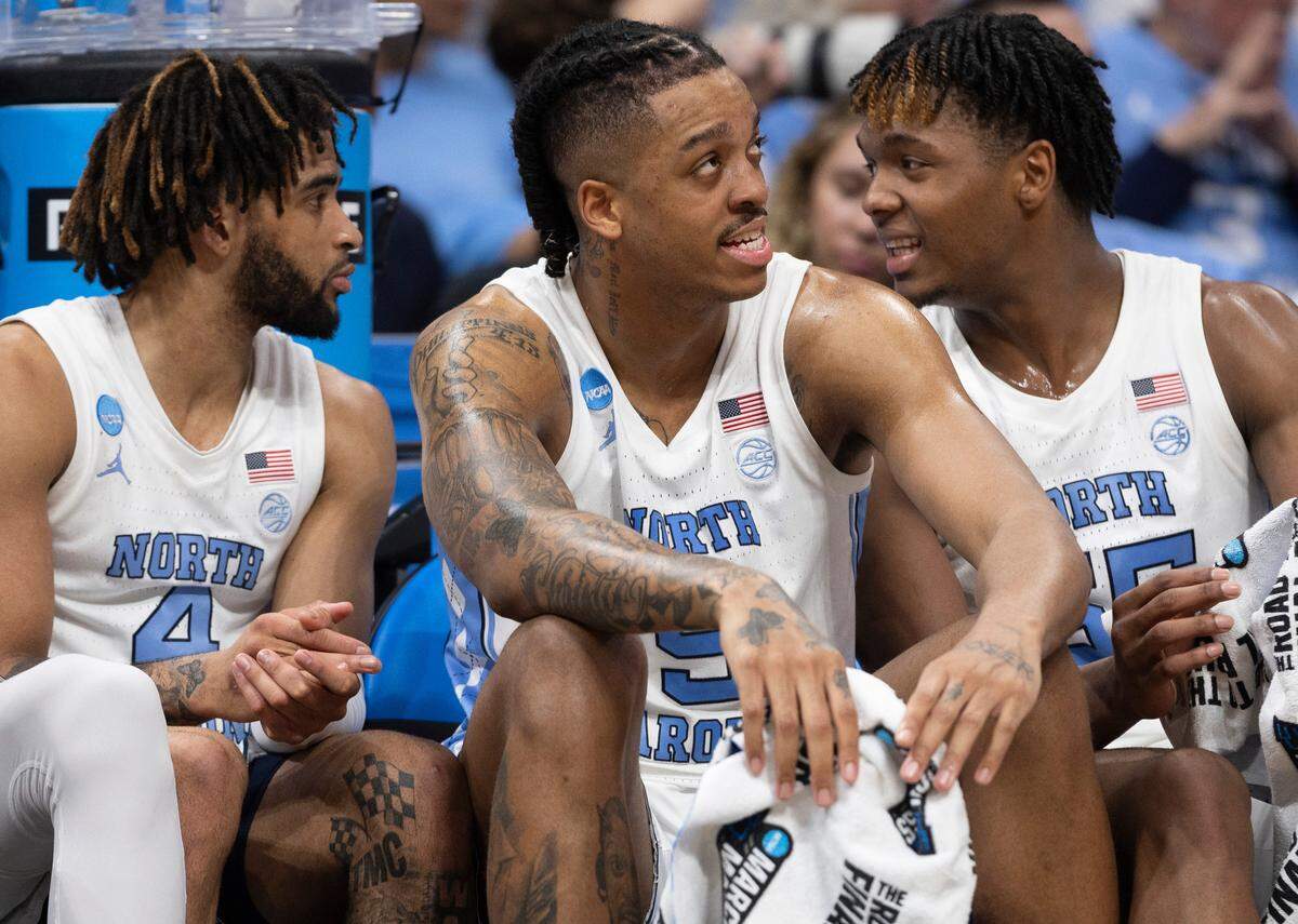 North Carolina’s R.J. Davis (4) and Harrison Ingram (55) chat behind teammate Armando Bacot (5) in the closing minutes of play against Wagner on Thursday, March 21, 2024 during the NCAA Tournament at Spectrum Center in Charlotte, N.C.