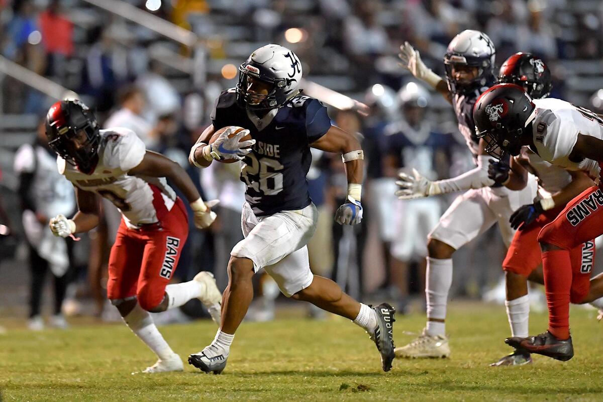 Hillside’s Jimmyll Williams (26) sprints for the touchdown ahead of the Rolesville defense in the second half. The Durham Hillside Hornets and the Rolesville Rams met in a football game in Durham, N.C. on September 9, 2022.