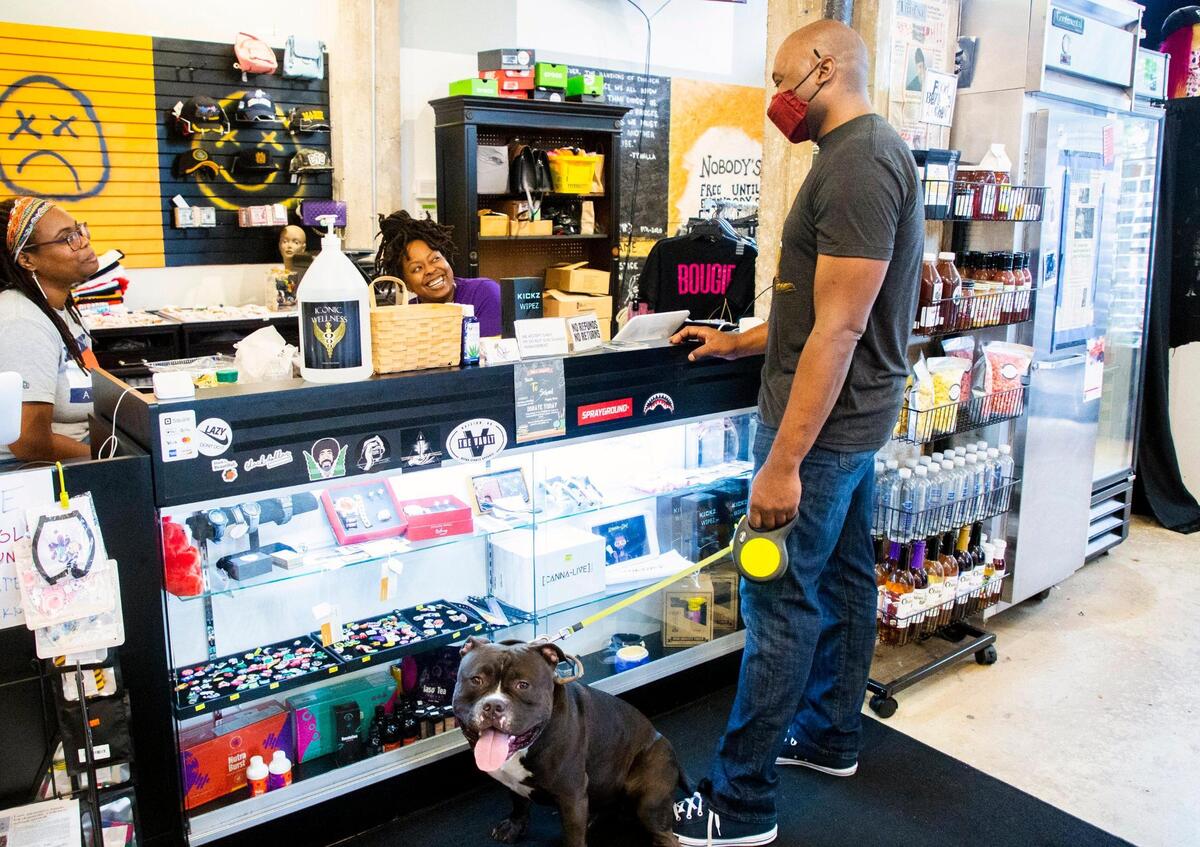 Robert Rouse, right, visits with Kayla Walker, left, and Jasmine Bullock in the Black Friday Market, which opened the storefront downtown in December 2019 to sell products and art from small, mostly Black-owned businesses, on Wednesday, Aug 4, 2021, in Raleigh, N.C.