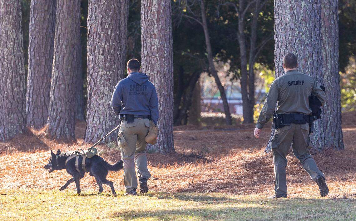 Law enforcement officers and a canine search Wendell Tuesday, Nov. 15, 2022 after 9-year-old Bentley Stancil went missing for more than 24 hours. Stancil was found safe, hiding in a camper.