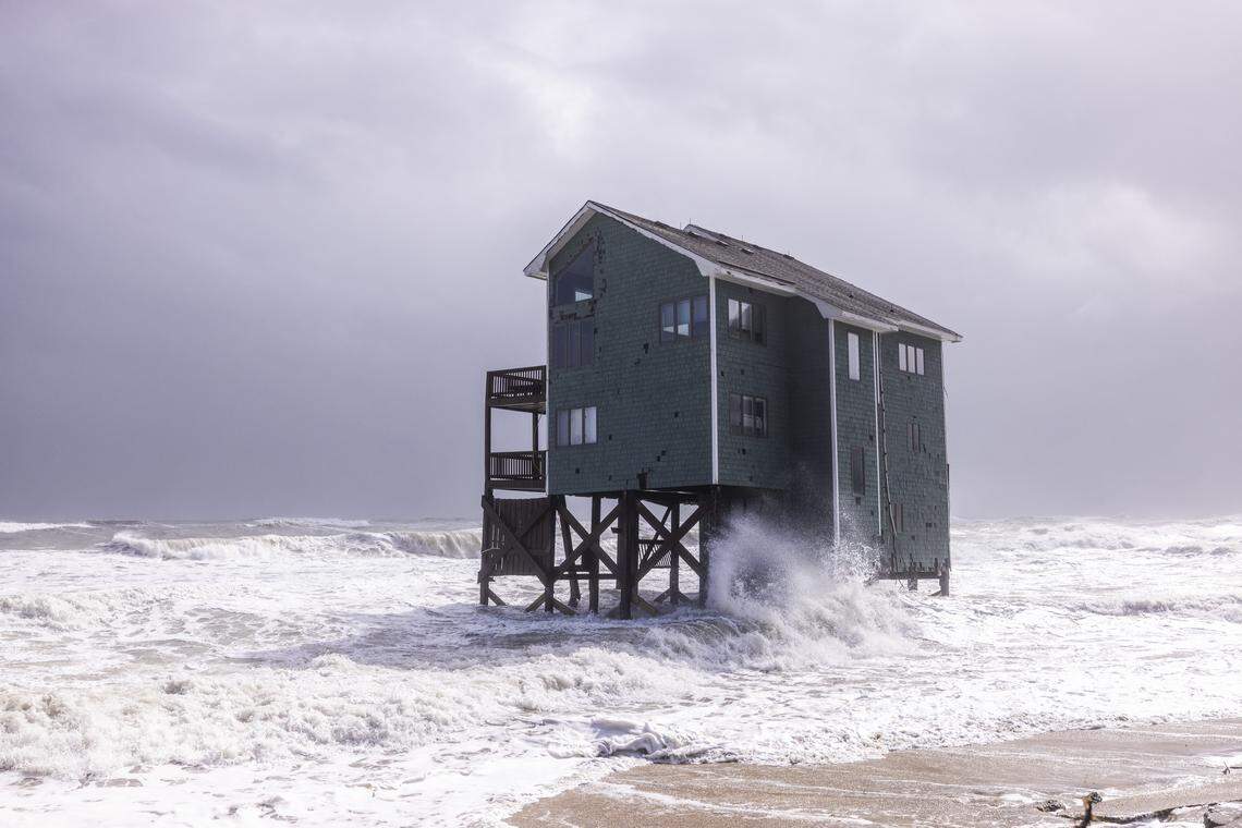 Rough surf pounds a beach home during high tide on Sunday, Oct. 12, 2025, in Buxton during a nor’easter. Sixteen homes in the community have collapsed into the Atlantic Ocean since mid-September.
