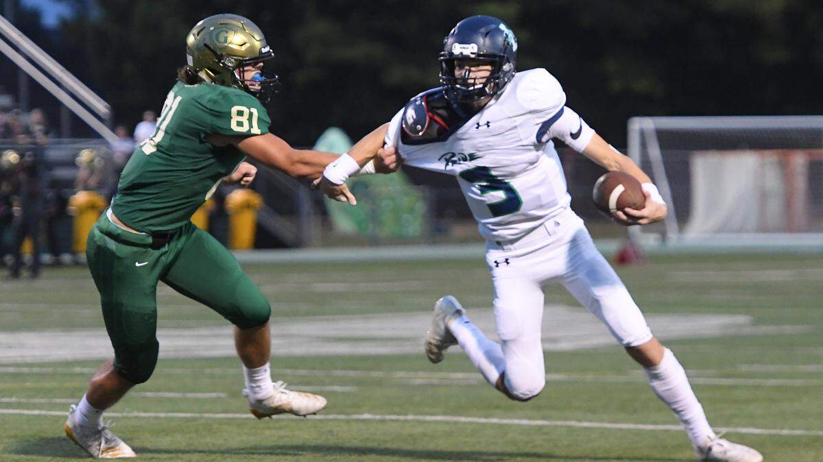 Trey Baker (3) of Leesville Road looks for a pass against pressure from Nicco Moriates (81) of Cardinal Gibbons. The Leesville Road Pride visited the Cardinal Gibbons Crusaders in a high school football game on September 27, 2019.