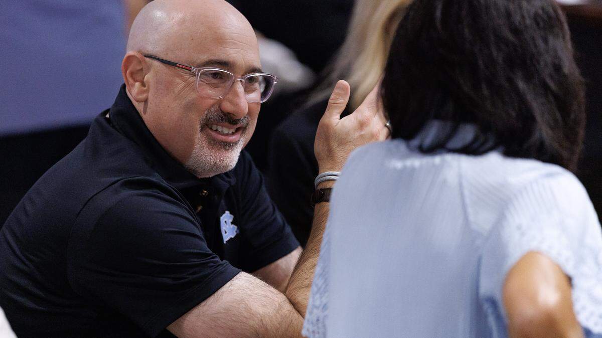 Steve Newmark, left, talks during a break in the "Carolina Football Live" radio show at Top of the Hill Restaurant & Brewery on Wednesday, Aug. 27, 2025, in Chapel Hill, N.C.