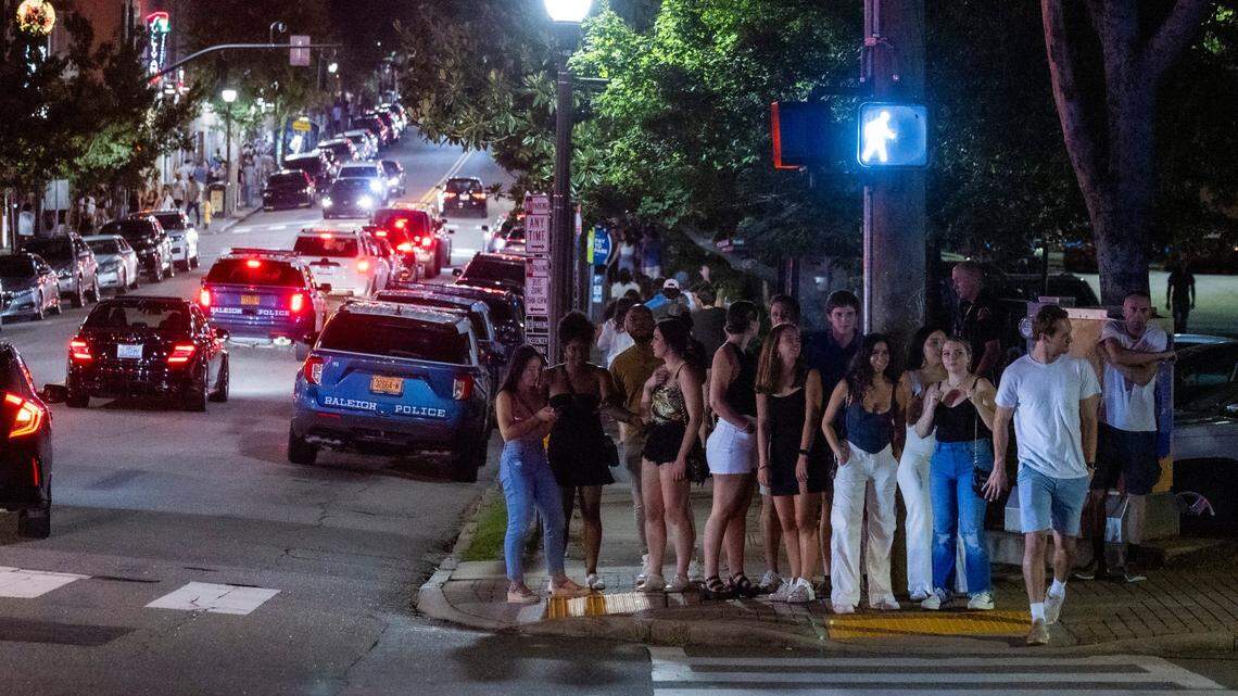 Club-goers prepare to cross the street shortly after midnight in the Glenwood South district on Friday, July 21, 2023.