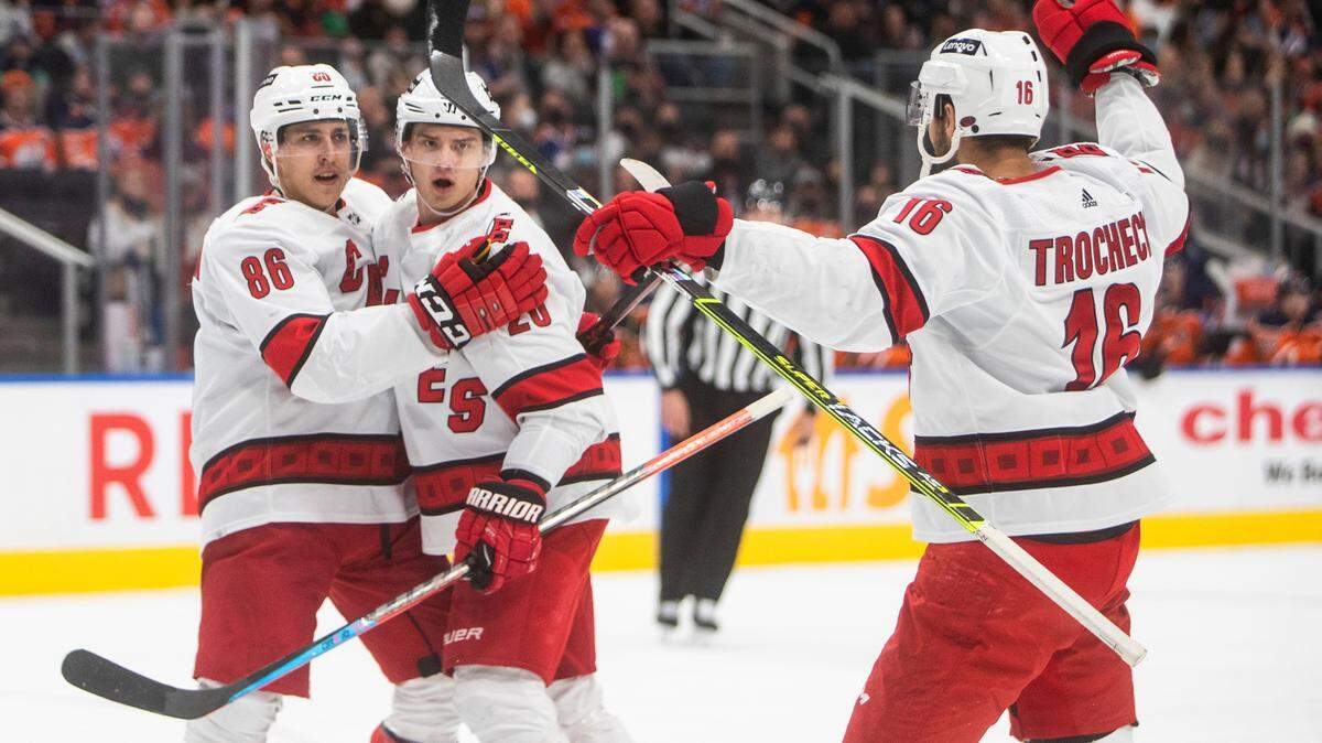 Carolina Hurricanes’ Teuvo Teravainen (86), Sebastian Aho (20) and Vincent Trocheck (16) celebrate a goal against the Edmonton Oilers during the first period of an NHL hockey game Saturday, Dec. 11, 2021 in Edmonton, Alberta (Jason Franson/The Canadian Press via AP)