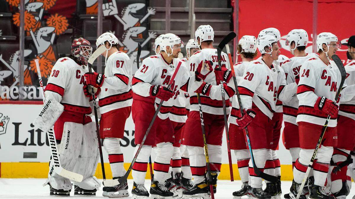 Carolina Hurricanes goaltender Alex Nedeljkovic (39) celebrates beating the Detroit Red Wings 2-1after an NHL hockey game Sunday, March 14, 2021, in Detroit. (AP Photo/Paul Sancya)