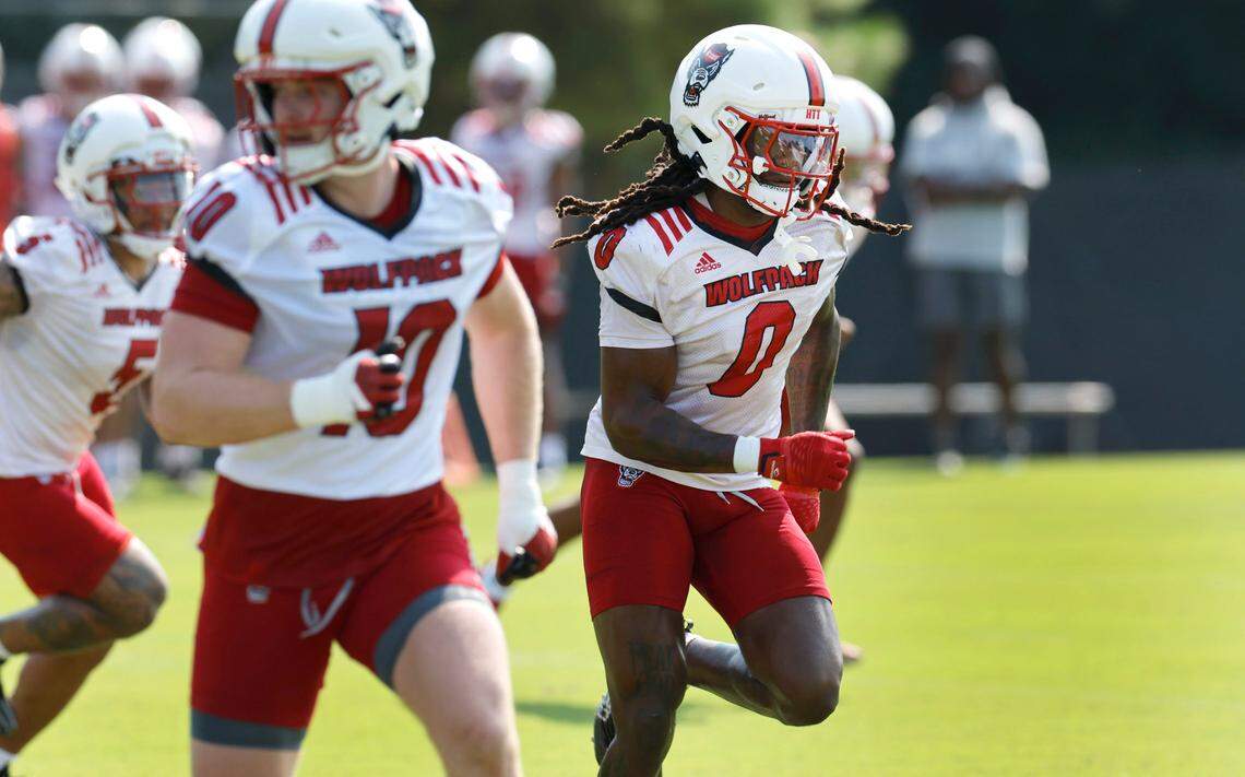 N.C. State linebacker Sean Brown (0) runs drills during the Wolfpack’s first practice in Raleigh, N.C., Wednesday, July 31, 2024. Linebacker Caden Fordham (10) is to the left.