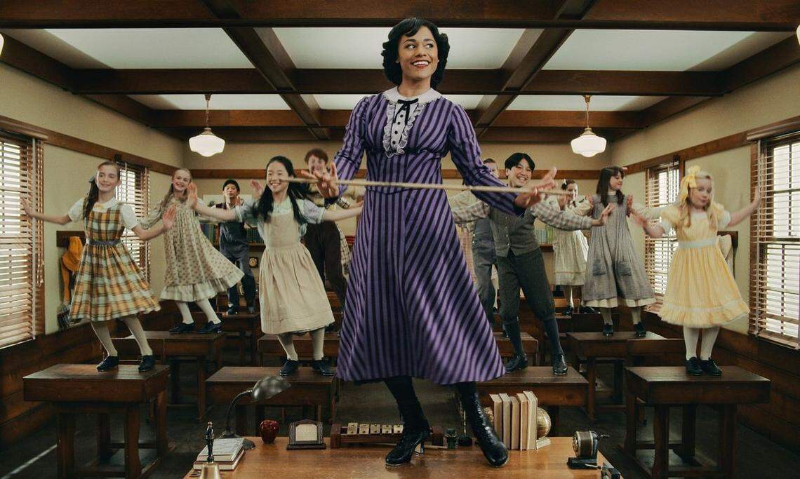 Ariana DeBose (center) as Emma Tate in the Apple TV+ musical comedy series “Schmigadoon.”