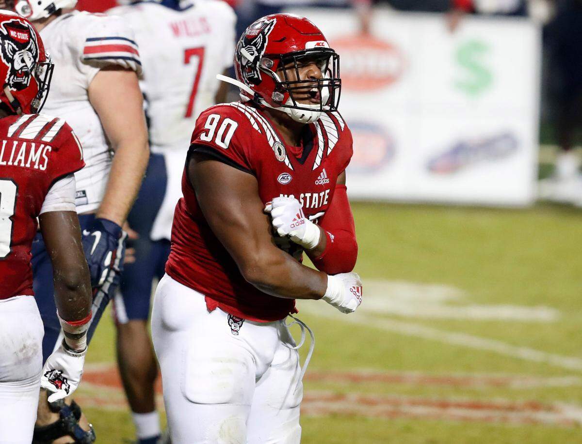 N.C. State defensive end Savion Jackson (90) celebrates after stopping Liberty running back Shedro Louis (1) for a gain of only one yard during the second half of N.C. State’s 15-14 victory over Liberty at Carter-Finley Stadium in Raleigh, N.C., Saturday, Nov. 21, 2020.