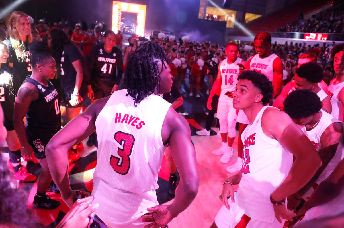 N.C. State’s Cam Hayes (3) and N.C. State’s Chase Graham (12) and the teams dance during Primetime with the Pack at Reynolds Coliseum in Raleigh, N.C., Thursday, October 14, 2021.