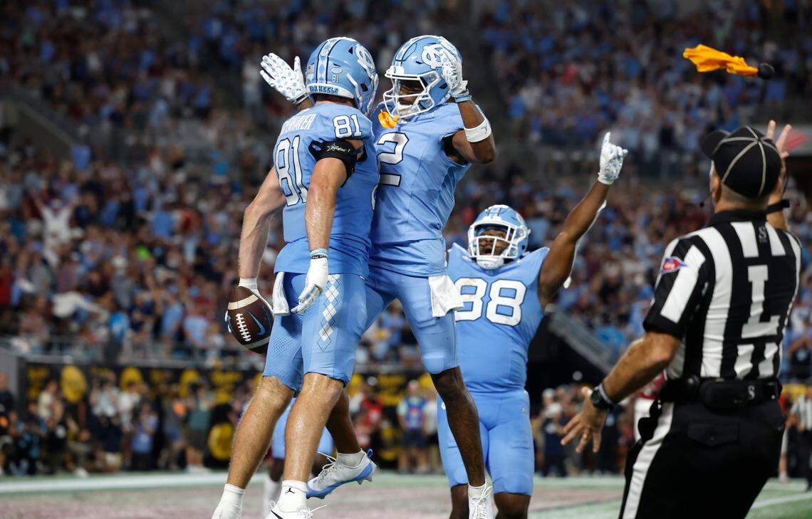 North Carolina tight end John Copenhaver (81) celebrates a 18-yard touchdown reception with Gavin Blackwell (2) during the second half of UNC’s 31-17 victory over South Carolina in the Duke’s Mayo Classic at Bank of America Stadium in Charlotte, N.C., Saturday, Sept. 2, 2023.