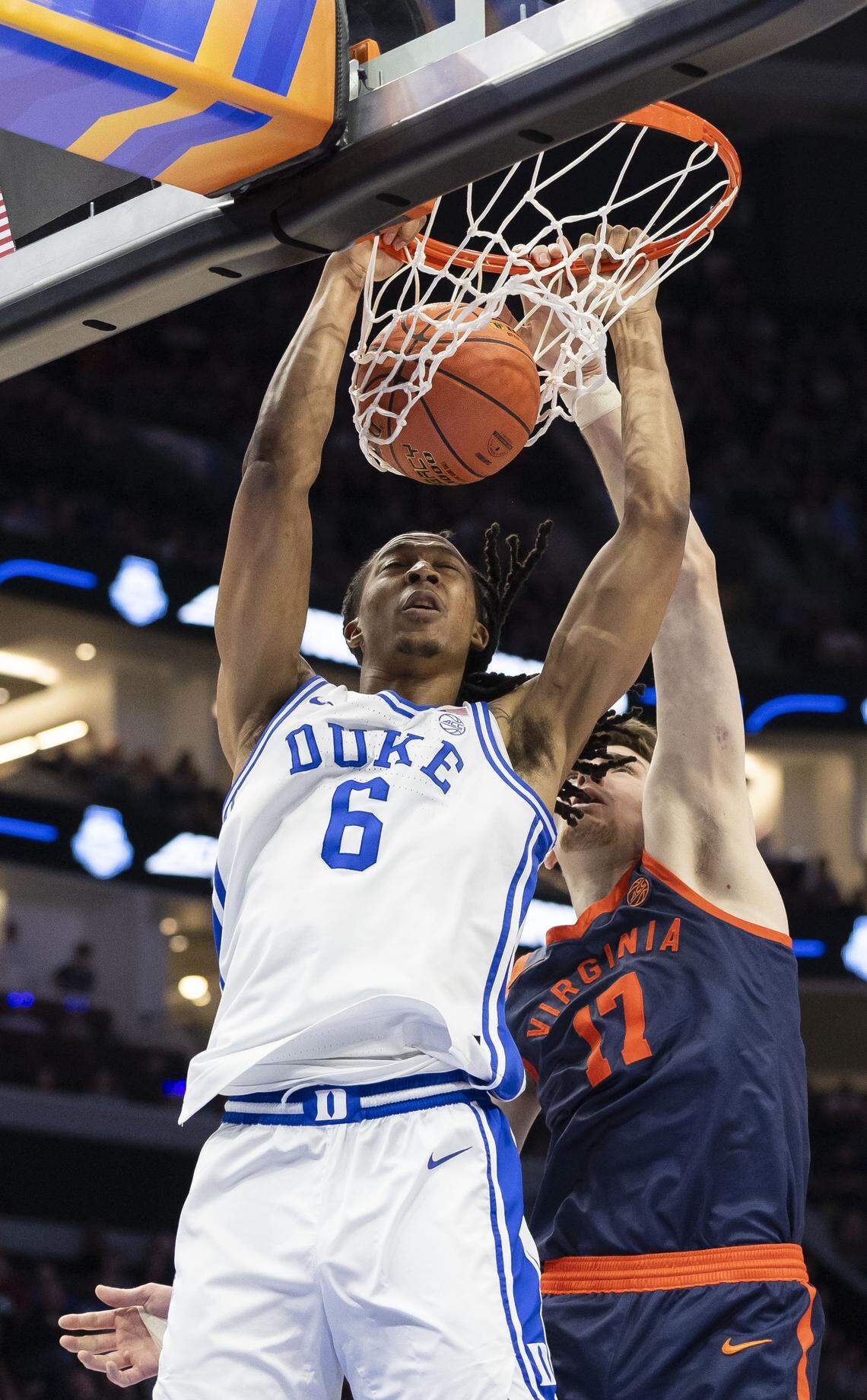 Duke forward Maliq Brown (6) dunks against Virginia center Johann Grunloh (17) in the first half against Virginia on Saturday, March 14, 2026, during the ACC Tournament Championship at Spectrum Center in Charlotte, N.C.