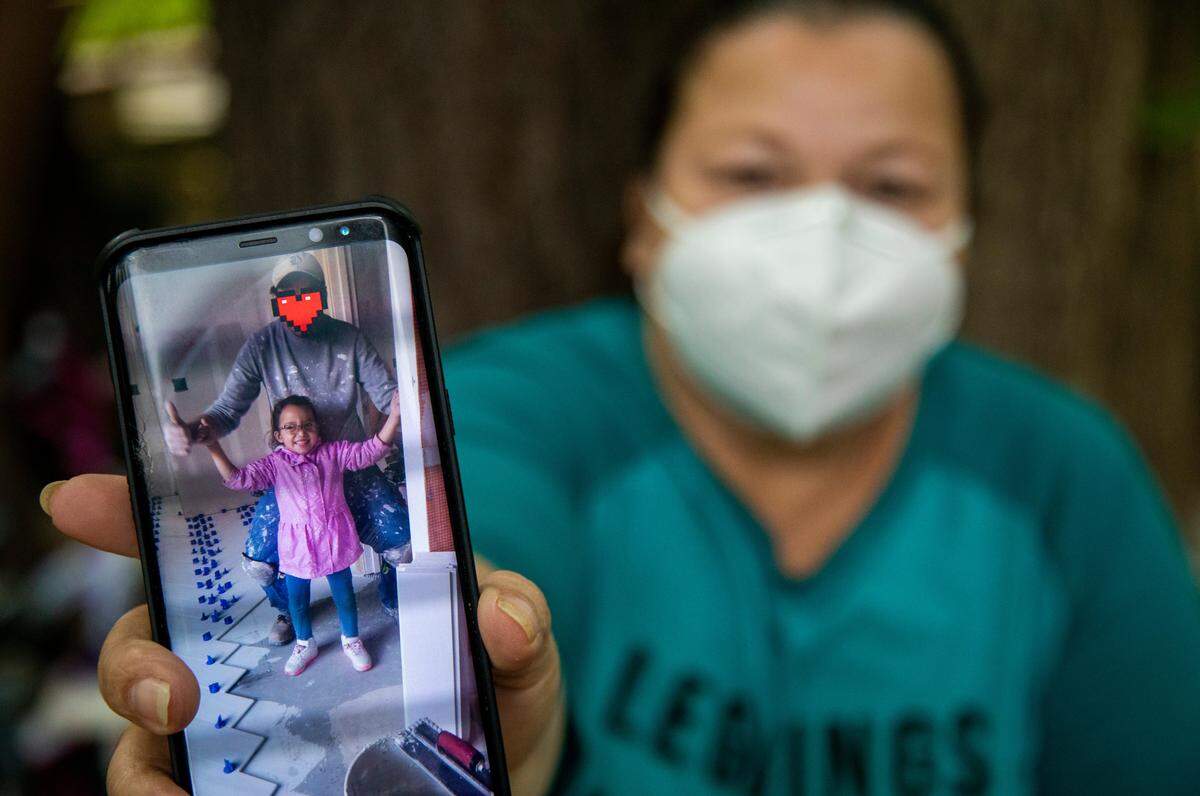 Lesly Zelaya, 47, shows a photograph of her daughter Bridget and her husband Mauricio Friday May 1, 2020. He was arrested by immigration officials for being in the country illegally and has been in immigration detention since February.