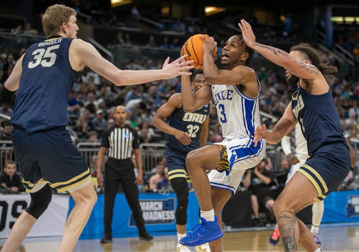 Duke’s Jeremy Roach (3) drives to the basket between Oral Roberts’ Connor Vanover (35) and Kareem Thompson (2) in the second half during the first round of the NCAA Tournament on Thursday, March 16, 2023 at the Amway Center in Orlando, Fla.