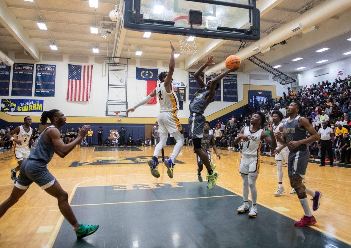 Kinston Vikings junior Jaylen Cobb (3) drives towards the basket against Farmville Central’s Derrick Cox (12) during their playoff game at Lee County High School in Sanford, N.C. on Saturday, March 5, 2022.