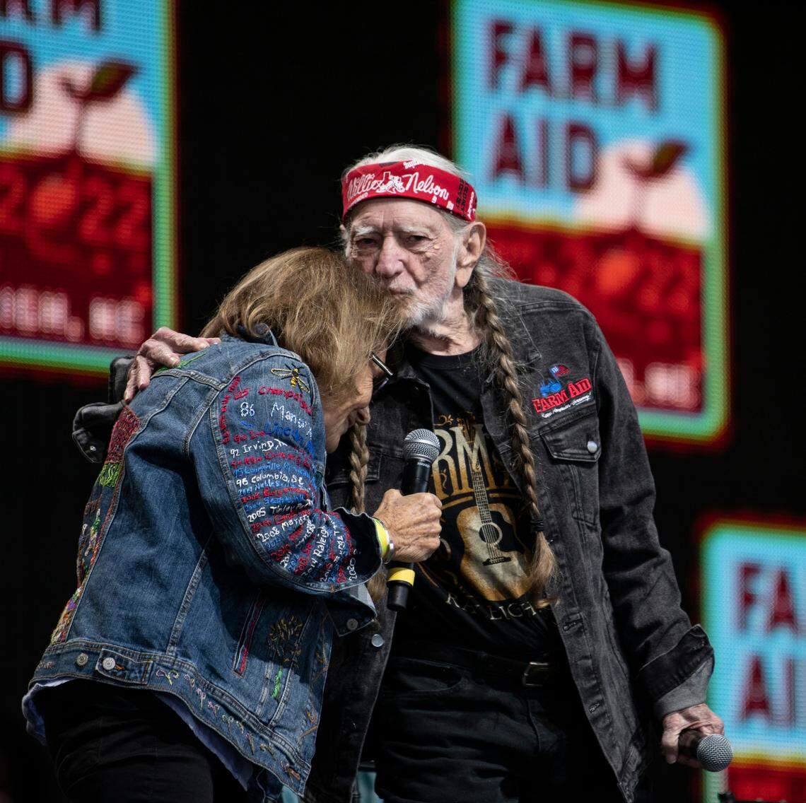 Willie Nelson thanks the director of Farm Aid before the start of the music festival Raleigh, N.C.’s Coastal Credit Union Music Park at Walnut Creek, Saturday, Sept. 24, 2022.