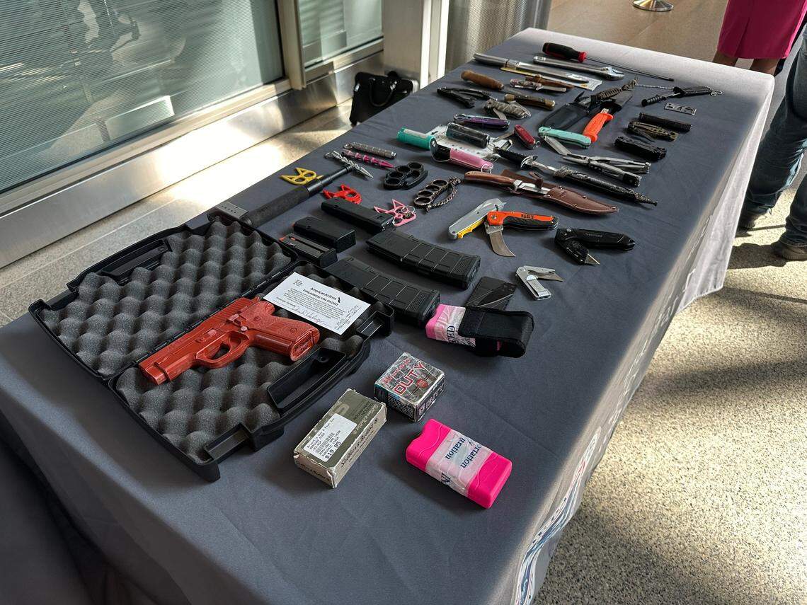 A sampling of the prohibited items that people tried to bring through the Transportation Security Administration checkpoint at Raleigh-Durham International Airport. The red gun is a dummy that the TSA used to show how firearms should be packed in carry on luggage.