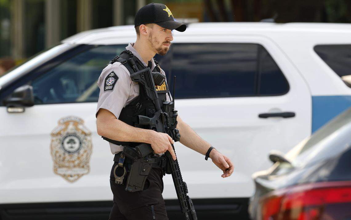 A Wake County sheriff’s deputy carrying a long gun works the scene at Triangle Town Center in Raleigh, N.C., Friday, April 17, 2026 following reports of a shooting.