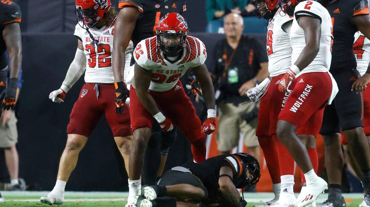 N.C. State linebacker Devon Betty (26) celebrates after stopping Miami running back Jaylan Knighton (4) for a two-yard loss during the second half of Miami’s 31-30 victory over N.C. State at Hard Rock Stadium in Miami Gardens, Fla. Saturday, Oct. 23, 2021.