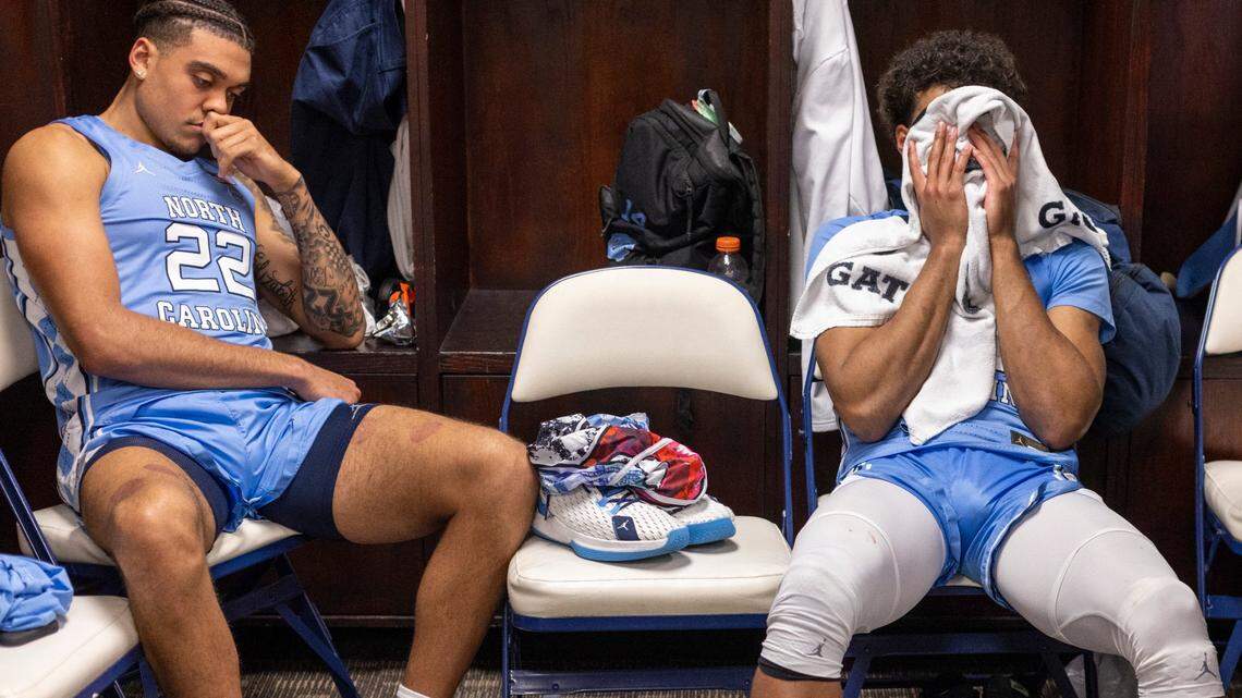 North Carolina’s Justin McKoy (22) and Puff Johnson (14) sit dejected in their lockers following the Tar Heels’ 68-59 loss to Virginia the third round of the ACC Tournament on Thursday, March 9, 2023 at the Greensboro Coliseum in Greensboro, N.C.