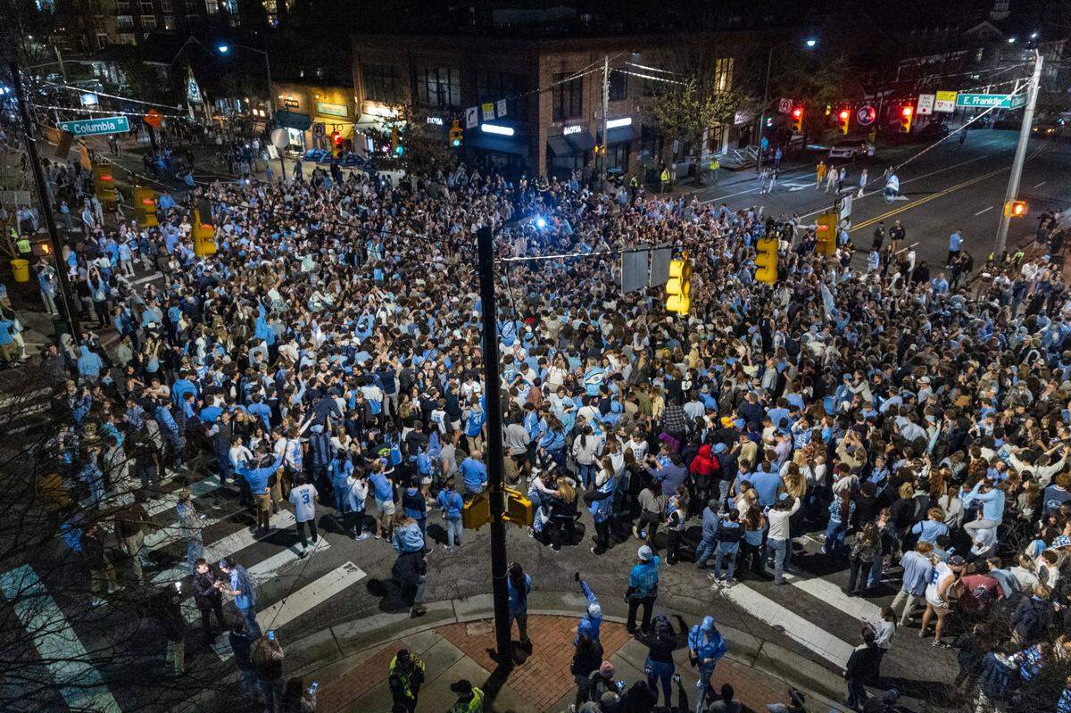 UNC-Chapel Hill basketball fans celebrate on Franklin Street following the UNC men’s basketball team’s 84-79 win over Duke at Cameron Indoor Stadium on Saturday, March, 9, 2024.
