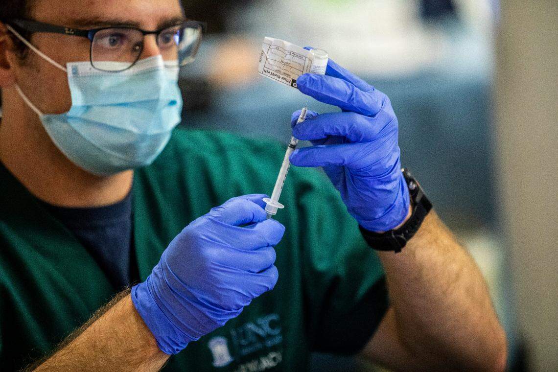 Pharmacy technician Cody Close prepares a dose of COVID-19 vaccine at UNC Health in Chapel Hill on Dec. 17, 2020.