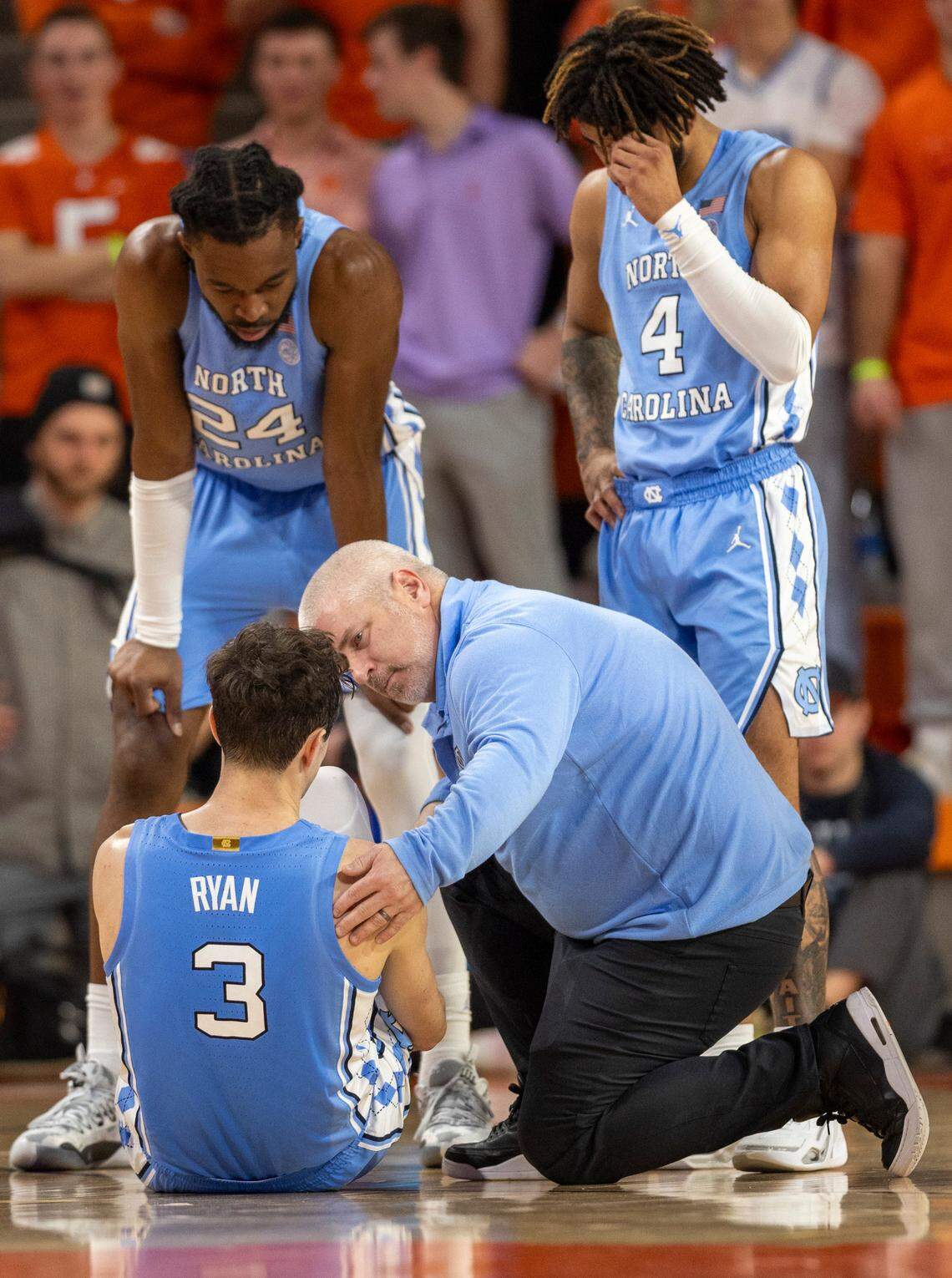 North Carolina trainer Doug Halverson checks on Cormac Ryan (3) after an injury in the first half against Clemson on Saturday, January 6, 2024 at Littlejohn Coliseum in Clemson, S.