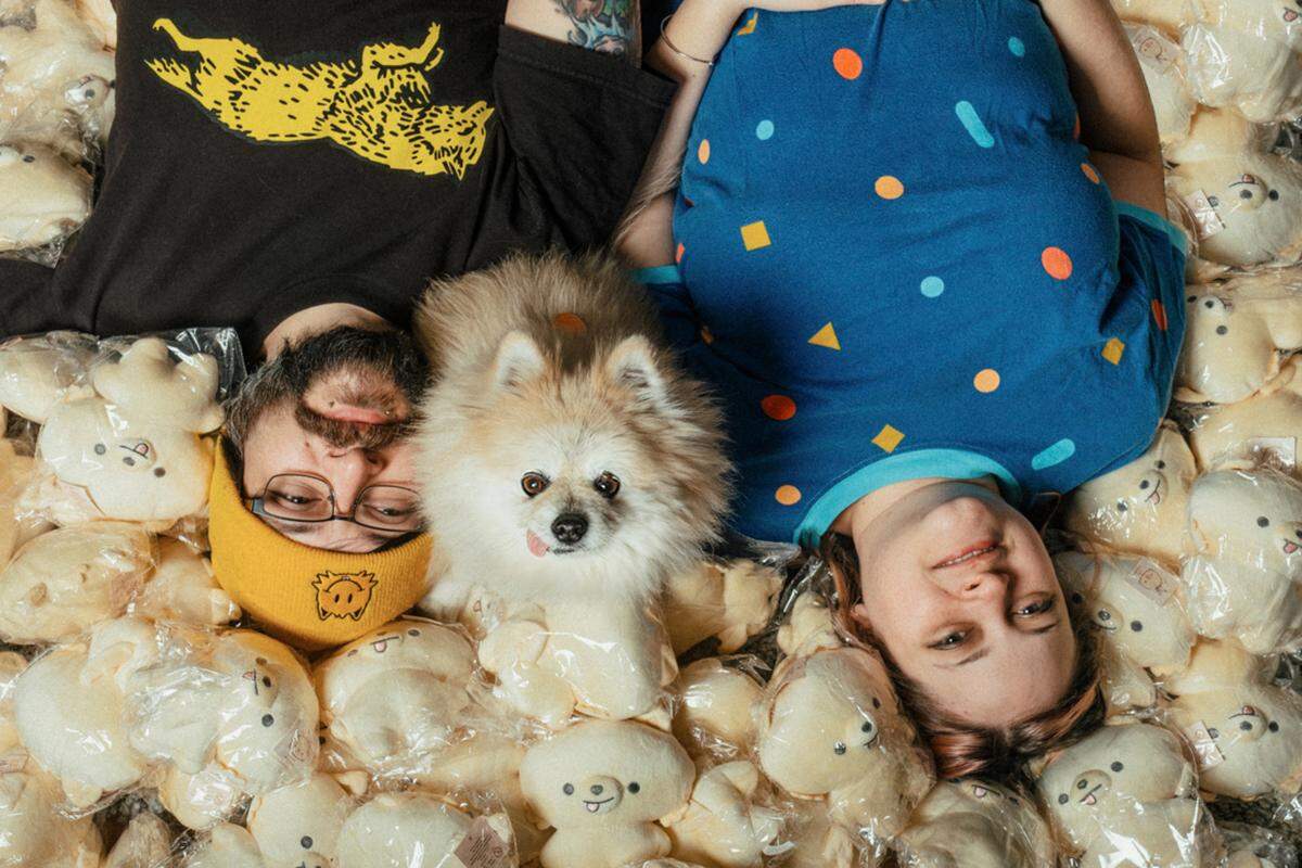Jamie Radar, Amber Echevarria and Munjo the Pomeranian pose for the camera.