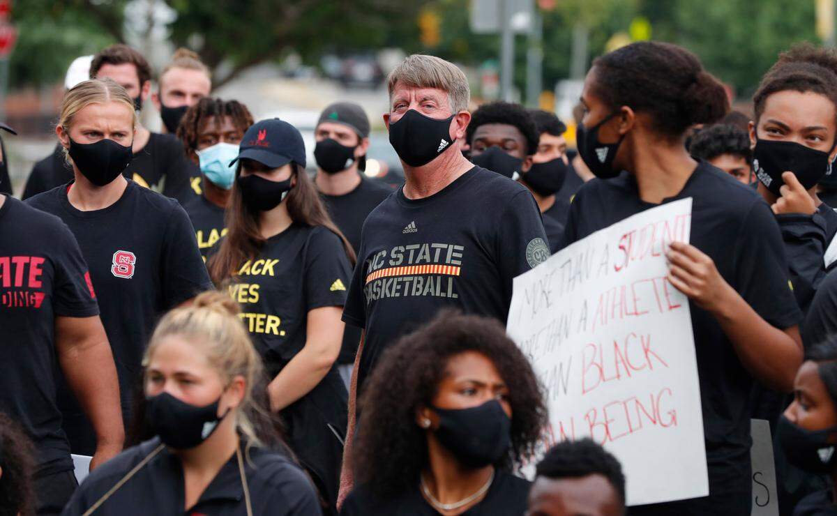N.C. State women’s basketball coach Wes Moore listens during a #PackUnited peaceful protest against racial and social injustice outside Holladay Hall on the campus of N.C. State Saturday, Sept. 12, 2020.
