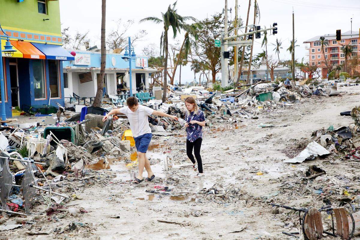 Jake Moses, 19, left, and Heather Jones, 18, of Fort Myers, explore a section of destroyed businesses at Fort Myers Beach on Thursday, Sep. 29, 2022. The community was mostly destroyed after Hurricane Ian made landfall on Wednesday.