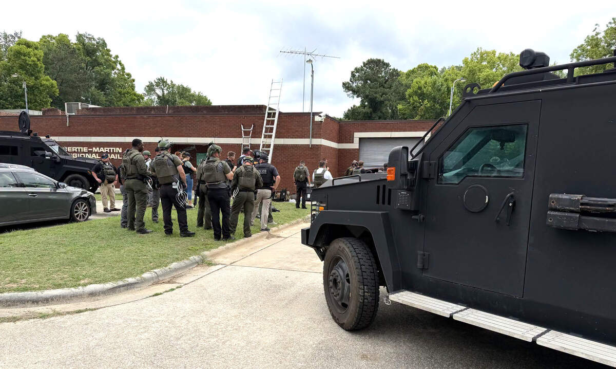 In this photo released by the N.C. State Bureau of Investigation, officers work at the Bertie-Martin Regional Detention Center in Windsor, N.C.