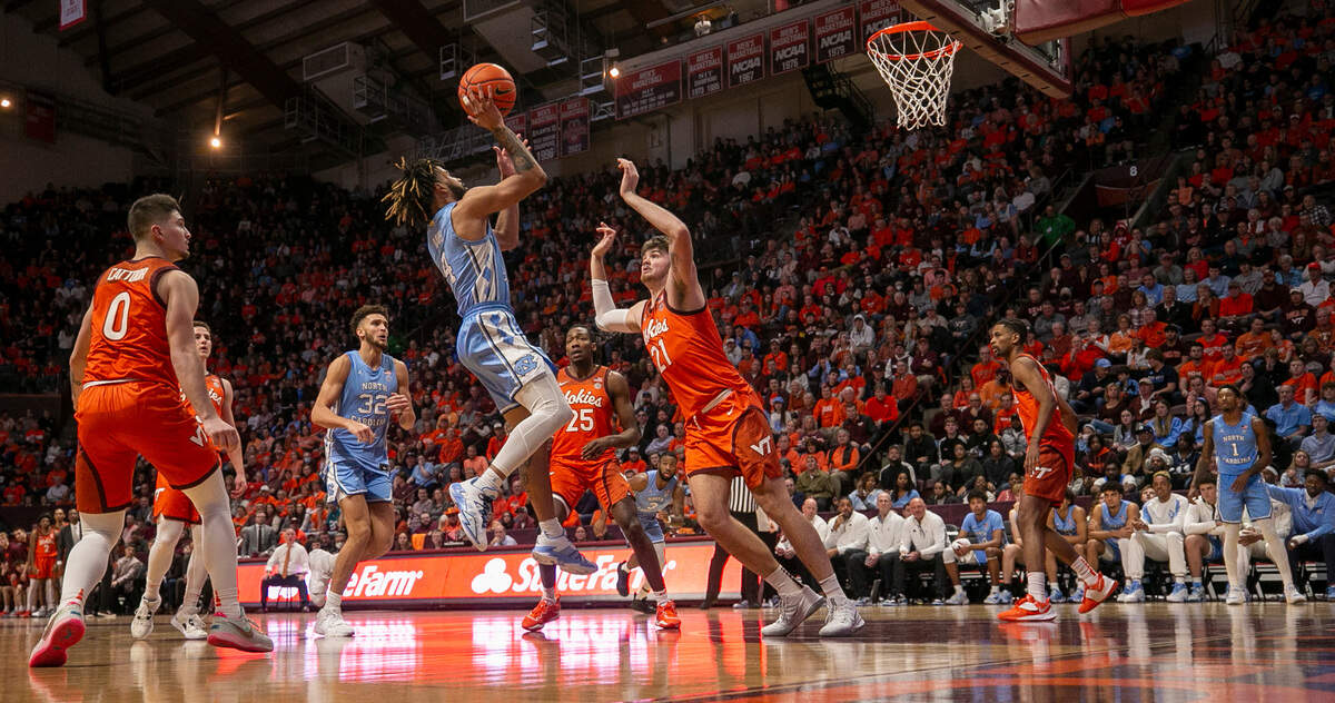 North Carolina’s R.J. Davis (4) puts up a shot against Virginia Tech’s Grant Basile (21) during the second half half on Sunday, December 4, 2022 at Cassell Coliseum in Blacksburg, Va. Davis scored 18 points in the Tar Heels’ 80-72 loss.