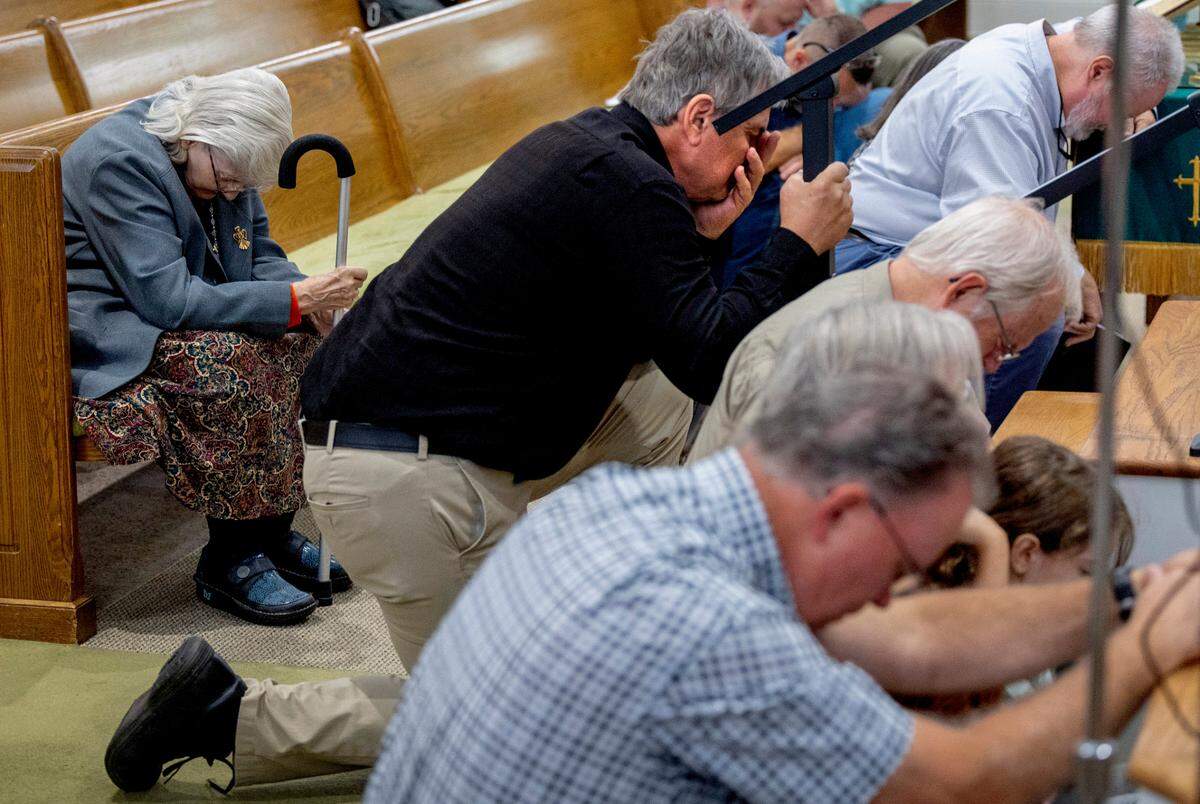 Congregants pray at the First Baptist Church in Waynesville on Sunday morning, Oct. 6, 2024. Waynesville is among the communities in western North Carolina impacted by the remnants of Hurricane Helene that caused catastrophic flooding.